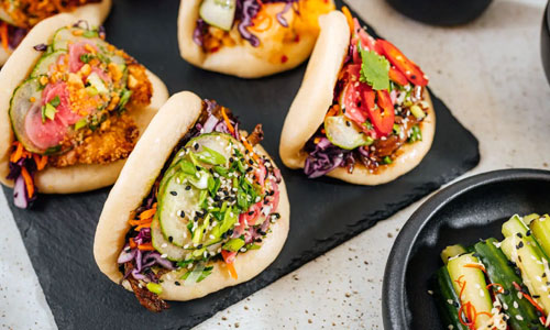 Fluffy steamed Bao Bun Rice Deluxe served with garnishes